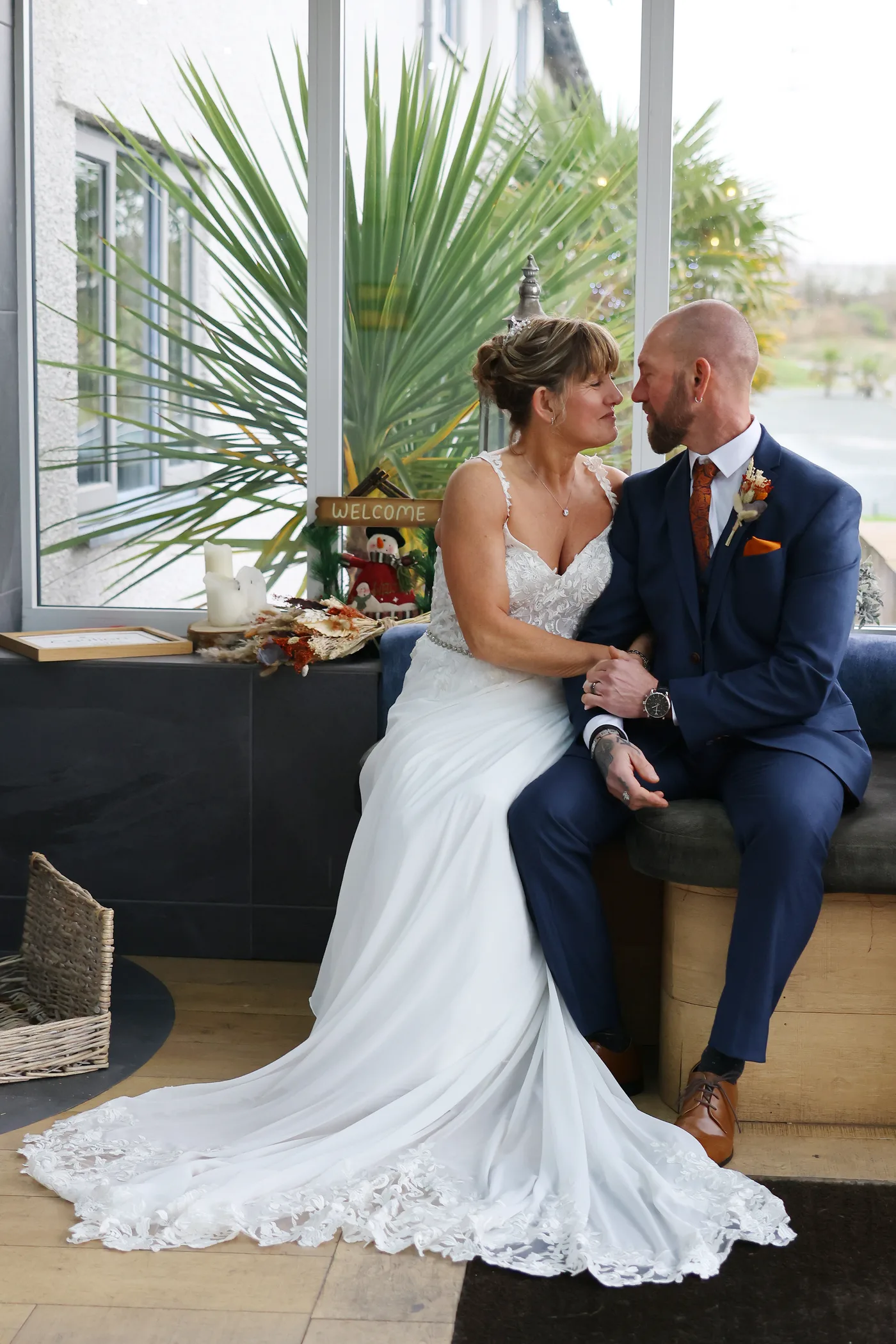 A couple together in the lounge by the palms