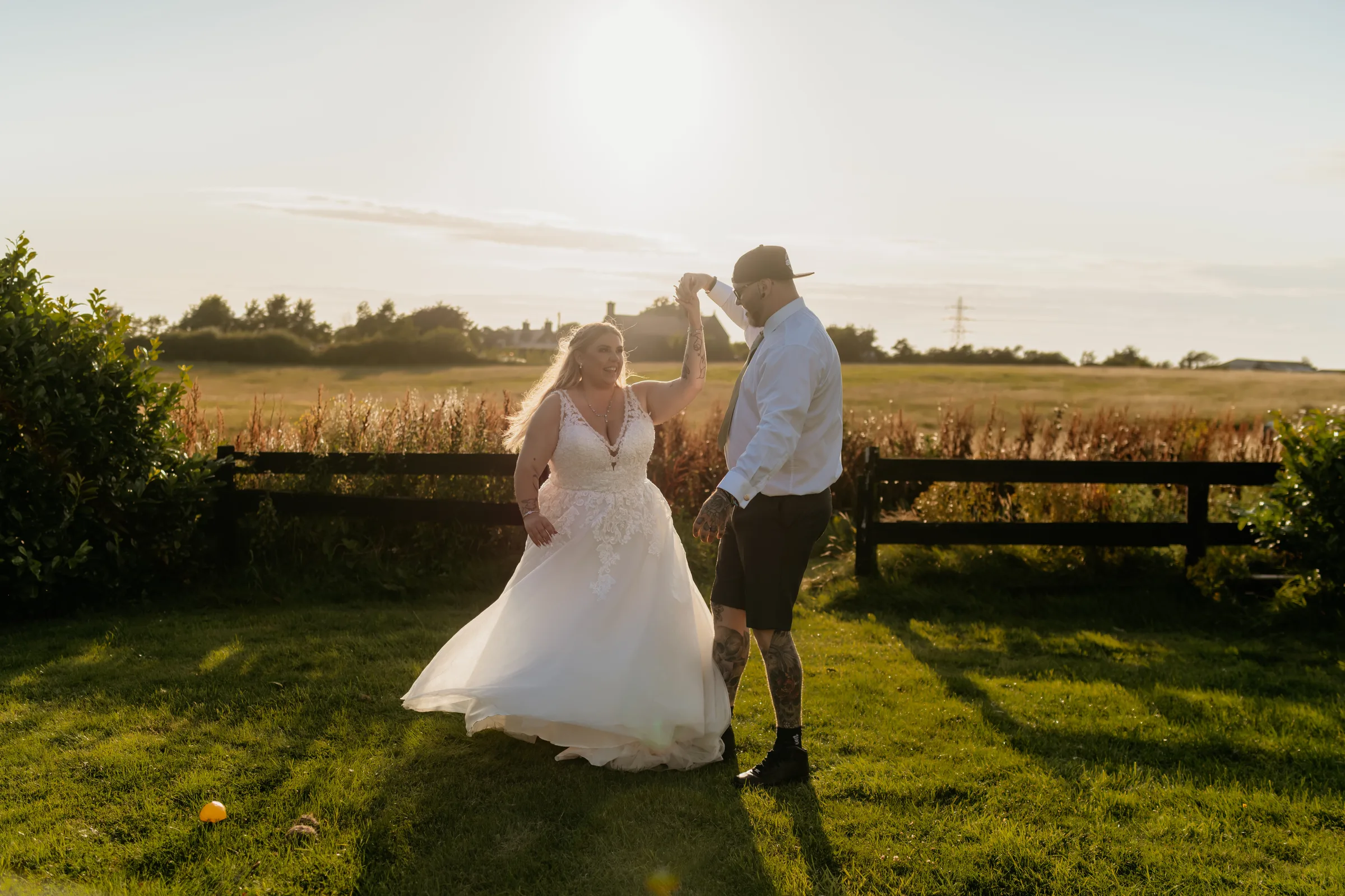 A couple dancing on the lawns at The Dunes Hotel at golden hour