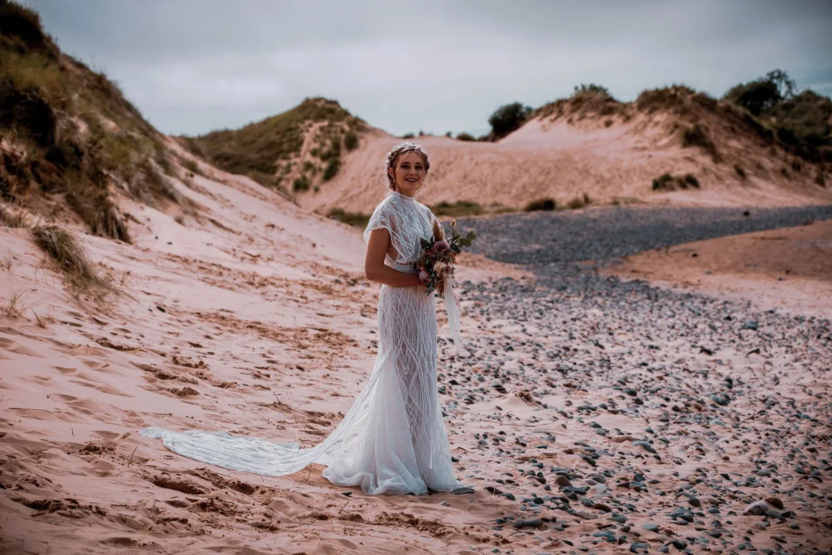 A bride in the sand dunes at Roanhead Beach, a minute down the lane